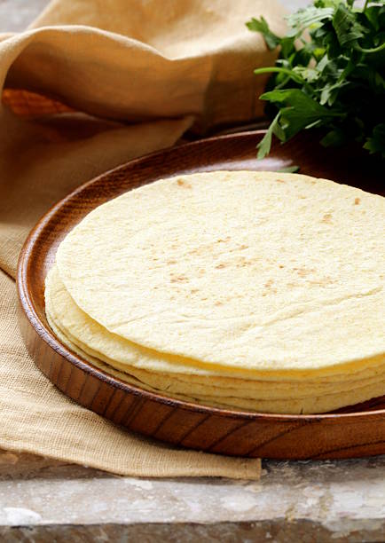 istock stack of corn tortillas on a wooden plate 187747214
