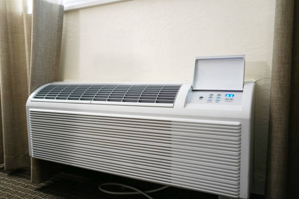 Air Conditioning Isolated on White Background. Modern Indoor Blocks of Split System Air Conditioner. Side View Close-up. Air conditioner on wall background