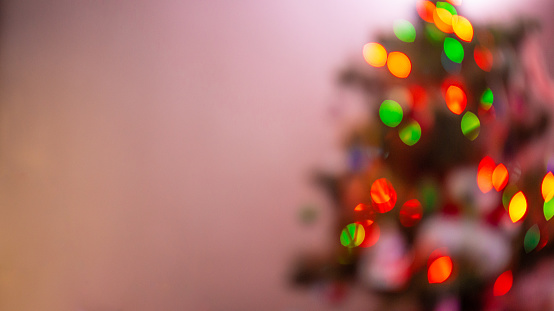 Christmas tree with glowing garland in blur