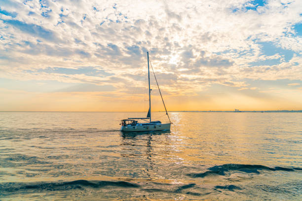istock Yacht in the sea at sunset 1877507496