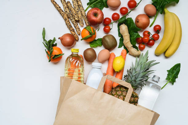 istock Paper bag with vegetables and fruits on white background. 1877513180