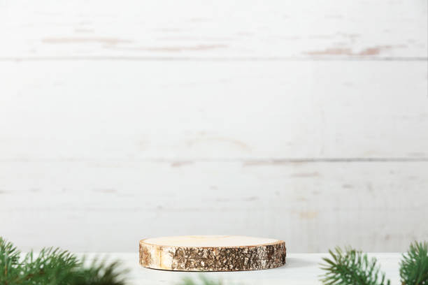 istock Wooden podium and christmas decorations on grey background. 1877542436