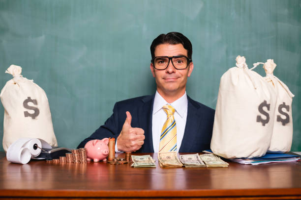 A businessman gives the thumbs up as he has made lots of money and savings for his business and future.