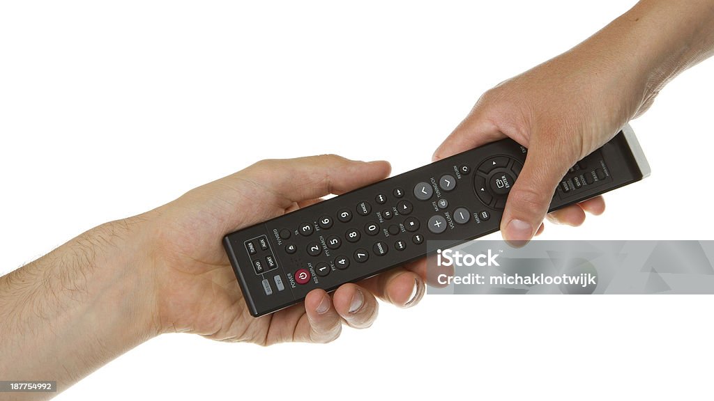 Man giving woman a black remote Man giving woman a black remote for a television Television Set Stock Photo