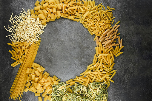 Italian dry pasta  in round shape on the table.