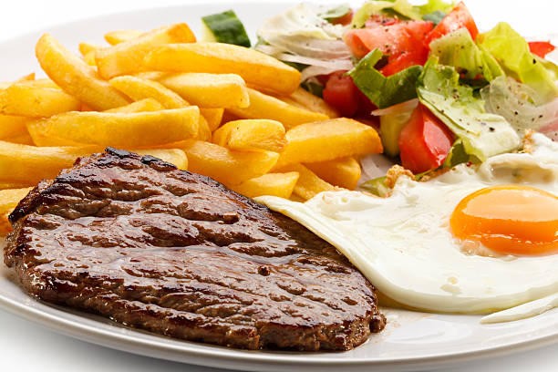 istock Beefsteak, fried egg, French fries and vegetables 187755325