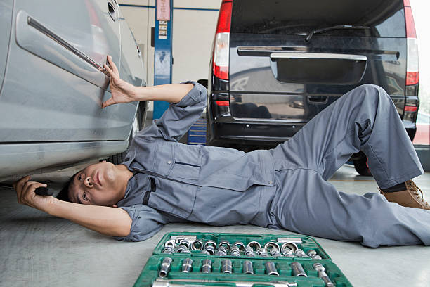 istock Mechanic Working on Underside of Car 187755518