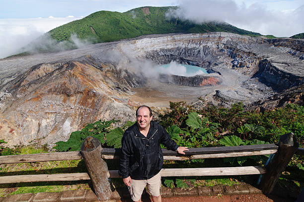istock Man standing in front of the Poas Volcano crater 187756076