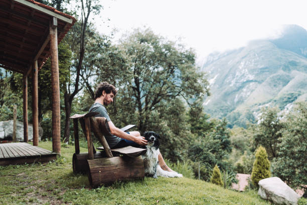Man using digital tablet at country house