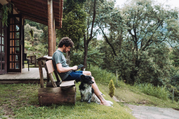 istock Man using digital tablet at country house 1877580329