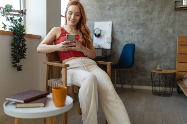 istock Beautiful woman using smart phone 1877597375