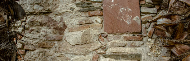 istock Close up old gray brick texture wall concept photo. Medieval architecture, backyard with palm trees 1877616347