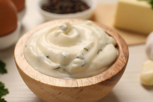 istock Tasty sauce with garlic on white table, closeup 1877642078