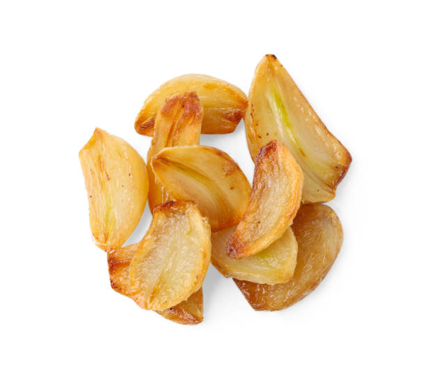 istock Fried garlic cloves isolated on white, top view 1877645265