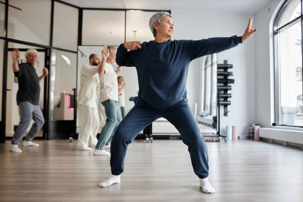 istock Senior Woman Practicing Qigong Archer Pose 1877662934