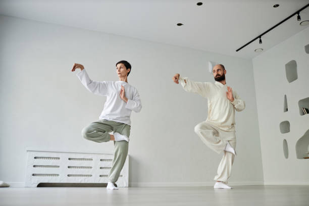 istock Female Student and Master Standing in Qigong Pose 1877663040