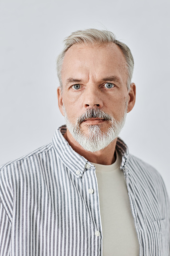 Studio portrait of blonde Caucasian man wearing gray shirt