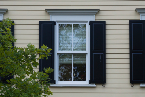 outdoor daylight view of black shutters
