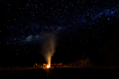 Camp fire with the Milky Way background on Busanga Plains in Zambia