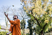 Mid adult man practicing juggling at the public park