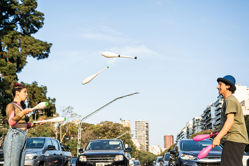 Jugglers performing in city traffic