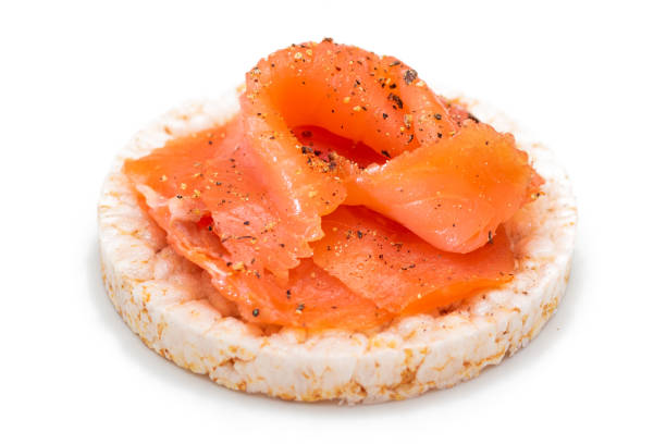 istock Rice Cake Sandwich with Fresh Salmon Slices Isolated on White 1877808317