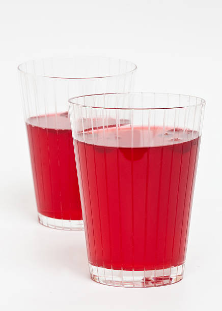 Two red cranberry fruit drinks Two red cranberry fruit drinks in the glass. marshwort stock pictures, royalty-free photos & images