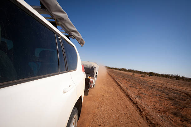 Touring Outback Australia - Four Wheel Drive Towing Camper Trailer stock photo