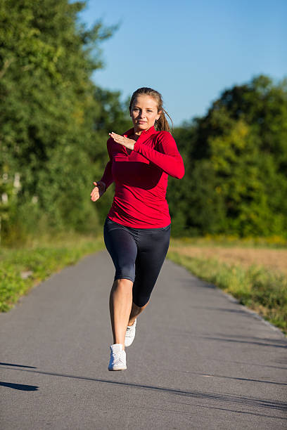 istock Woman jogging in park 187783069