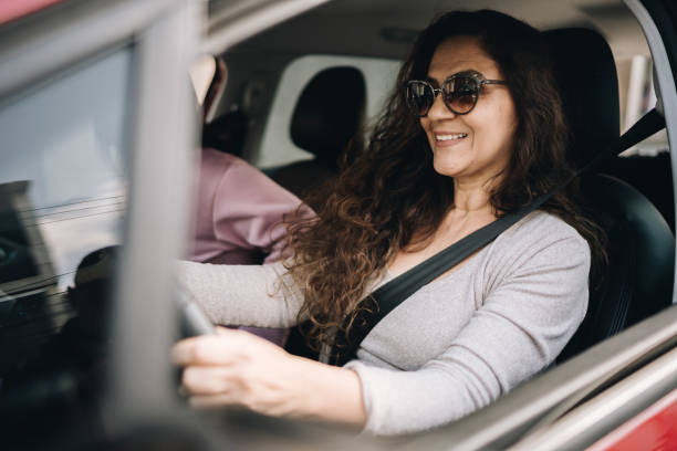 istock Mature woman driving car 1877833064