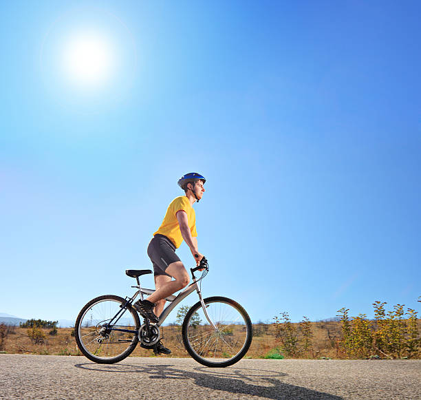 istock Young male with helmet riding a bike 187783341