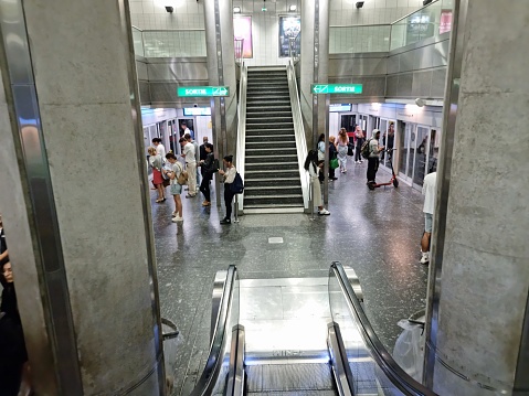 The Toulouse Metro is the only Metro system in Occitanie. The Toulouse Metro consists of two primarily underground metro lines, Line A and Line B, that together serve 37 stations. The image shows the interior of a Metro station with several people.