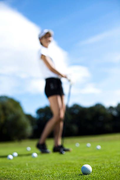 istock Woman playing golf on field 187785057
