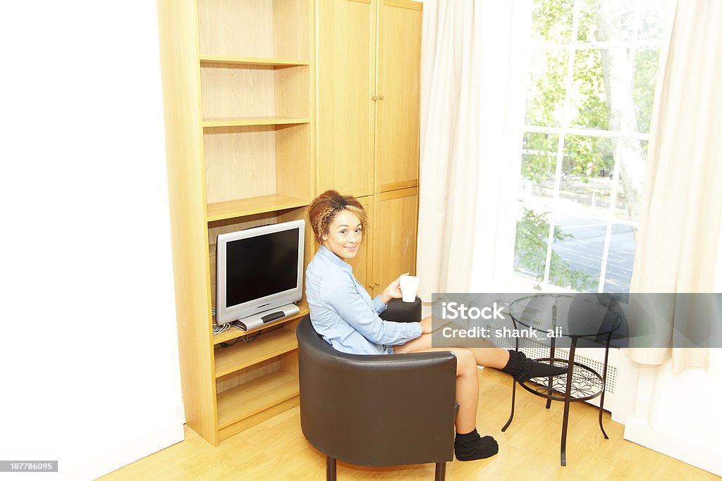 women chilling in her apartment A young women relaxing in her apartment 20-24 Years Stock Photo