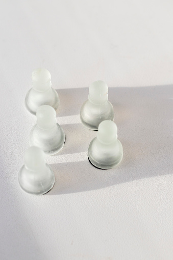 Shot of the chess pieces, pawns, casting shadow in the shape of a crown