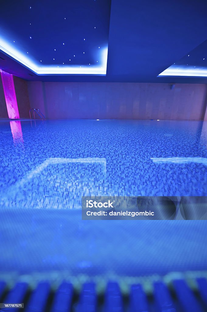 Blue toned indoor pool Blue toned indoor swimming pool. Selective focus. Activity Stock Photo