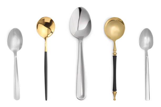 istock Stylish golden and silver spoons on white background 1877877766