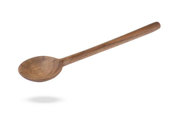 istock Wooden spoon in air isolated on white 1877877769
