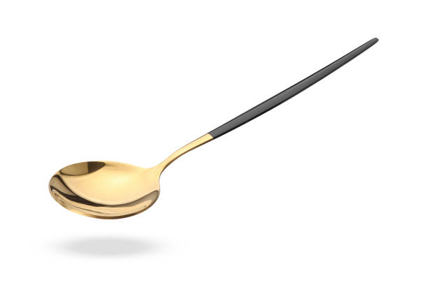 istock Golden spoon in air isolated on white 1877880908