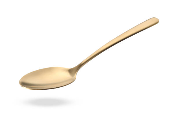 istock Golden spoon in air isolated on white 1877881967