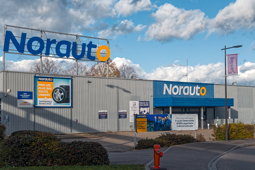 Vendenheim, France - November 19, 2023: The Norauto store in the commercial zone in Vendenheim near Strasbourg, Alsace, France. Entrance with advertising and store sign. View from a public street. Norauto is a retailer in the branches car repairs, car accessories and car parts.