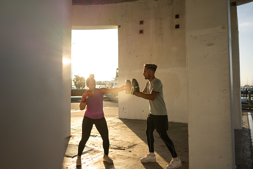 A pair of young pacific islander friends exercising during sunset
