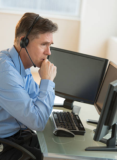 istock Male Customer Service Representative Looking At Computer Monitor 187789475