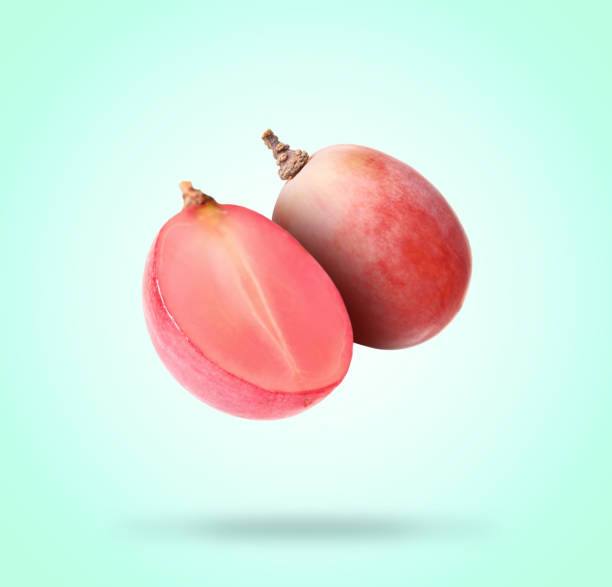 istock Sweet fresh grapes falling on turquoise background 1877900023