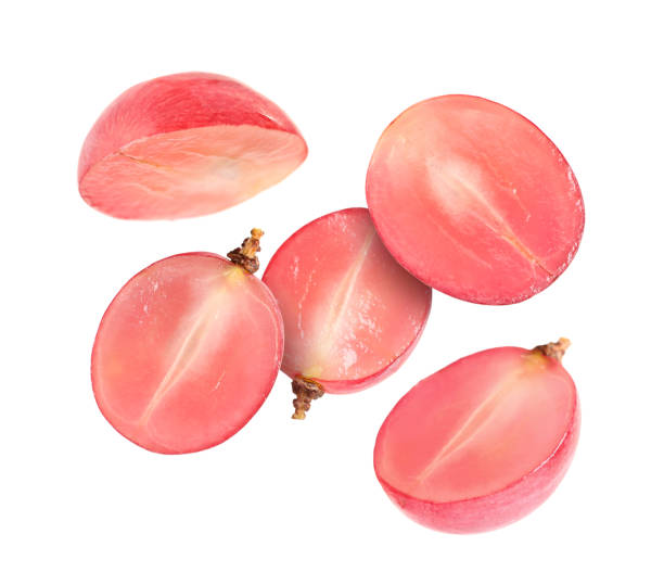 istock Halves of fresh grape falling on white background 1877900030