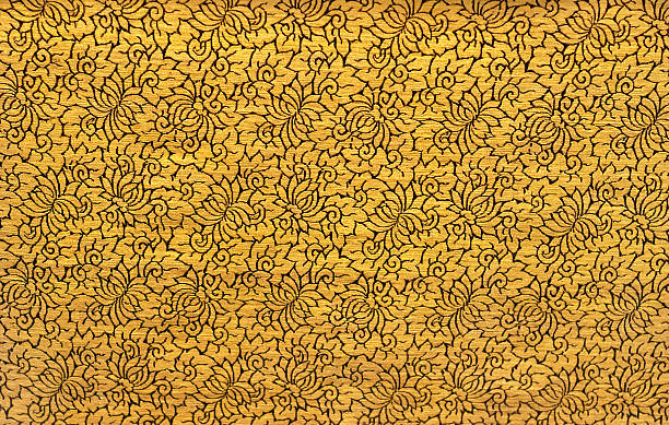 A golden Chinese textured textile with a floral design
