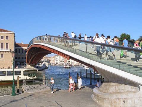 Venice, Italy - September 08, 2023: People on Ponte della Costituzione translation Constitution Bridge over Grand Canal designed by Santiago Calatrava