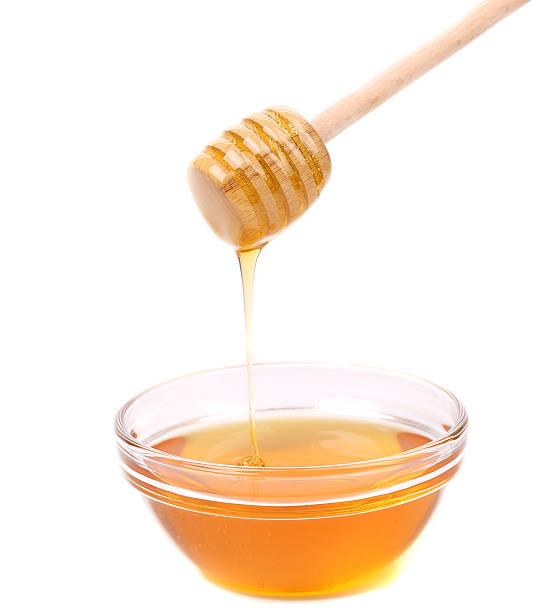 istock Honey dripping from a wooden dipper. 187791616