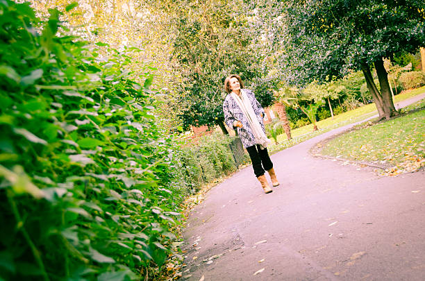 istock Senior Woman Walking in Park 187791654