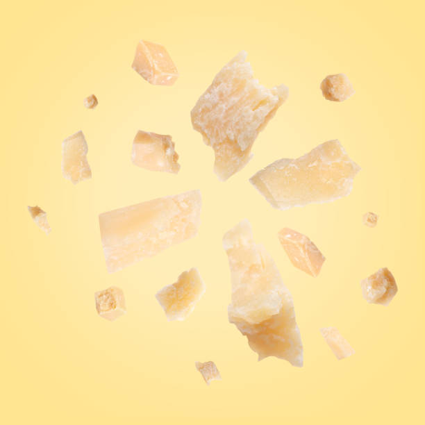 istock Parmesan cheese in air on pale yellow background 1877917032